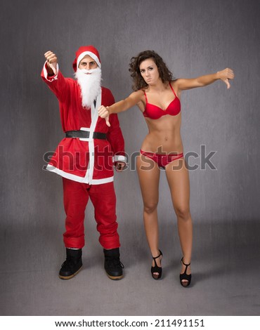 Santa Claus with woman thumbing down