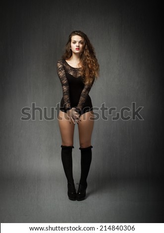 girl with socks over knees waiting in gray background