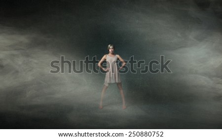 model with open legs posing in a dark room