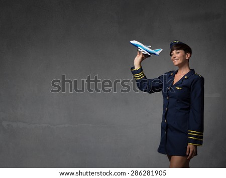 hostess plaing with a toy plane, dark background