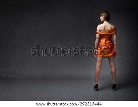 girl in orange dress, back side