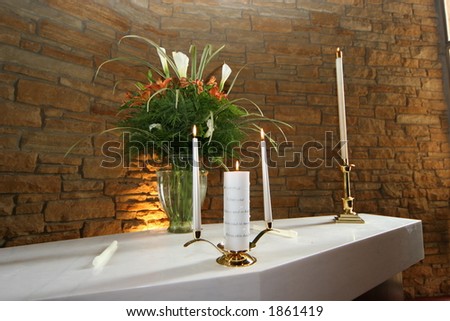 stock photo Unity candle and flowers on altar at a wedding