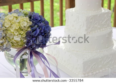 Detail of hydrangea bouquet with wedding cake.