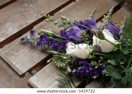 bride\'s bouquet on wooden seat