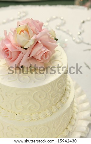 Detail of traditional wedding cake with pink and cream roses.