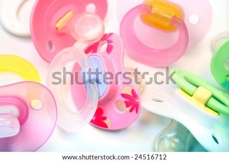 assortment of pacifiers, mostly pink