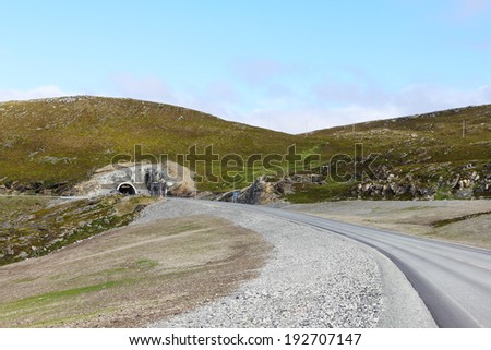Landscape with asphalt road tunnel in norwegian mountains