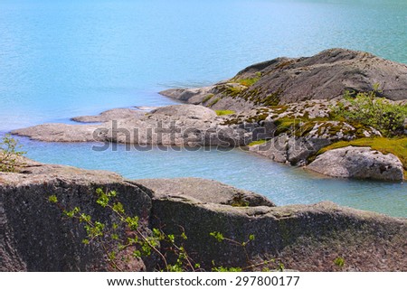 Stones in pure blue glacial river in Norway