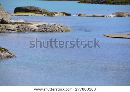 Stones in pure blue glacial river in Norway