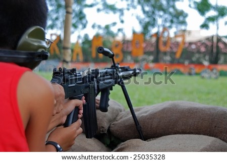 firing machine gun in the army camp