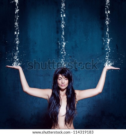 water-spa girl is meditating under waterfall
