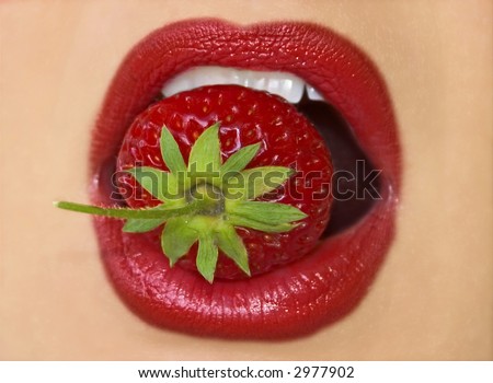 red lips eating strawberry close-up
