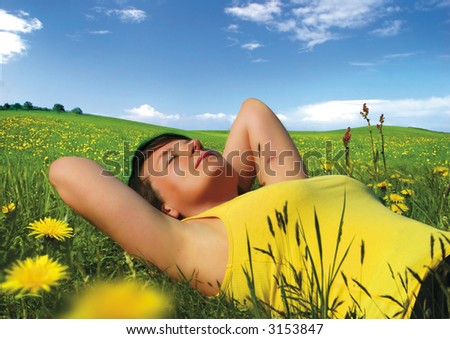 girl lying in a meadow enjoying the sun. More pictures like this in my portfolio.