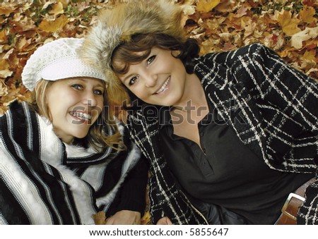 two cute girls having fun on an autumn-day. keyword for this collection is \