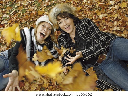 two cute girls having fun on an autumn-day. keyword for this collection is \