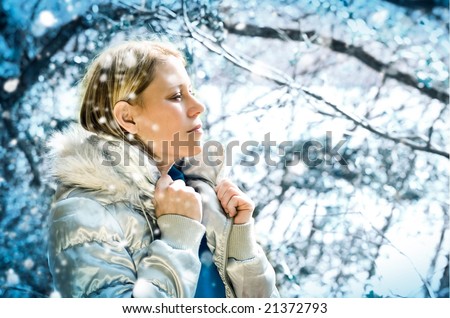 beautiful girl taking a walk in a winter forest