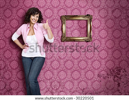girl standing in front of a pink wallpaper