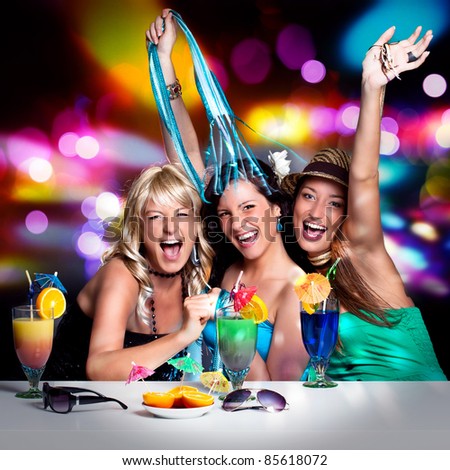 three beautiful girls celebrating in a club
