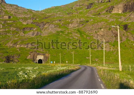 Uttakleivveien, single lane road on Lofoten Islands leading into narrow tunnel