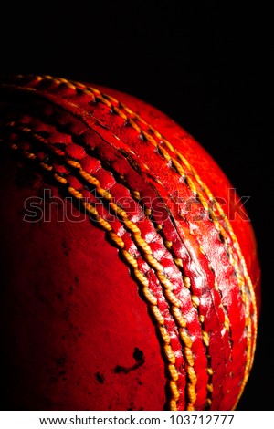 red ball cricket on a black background