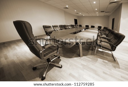 a large table and chairs in a modern conference room