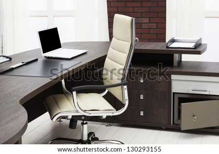 laptop on a desk in a modern office