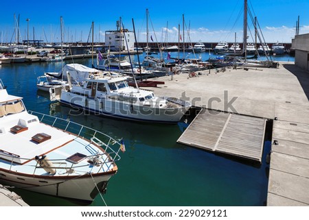 modern yachts docked in a port