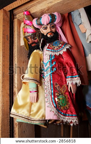 Dolls from a puppet theater weighing on a wall