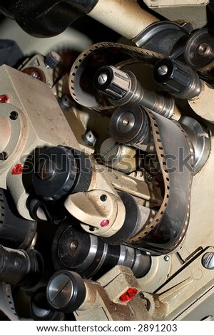 Fragment of an old film projector with a film