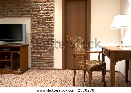 The TV and table with a lamp in modern hotel