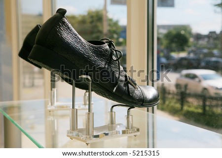 Man\'s low shoes on a show-window of shoe shop