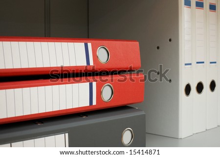 Folders for documents on a book shelf at office