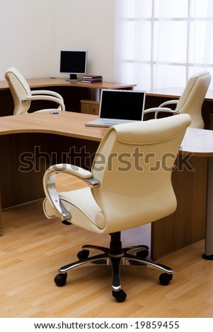 Beige leather armchairs at modern new office