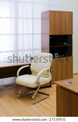Table, chairs and bookcase at modern office