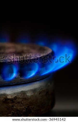 Gas burning by a dark blue flame on  kitchen