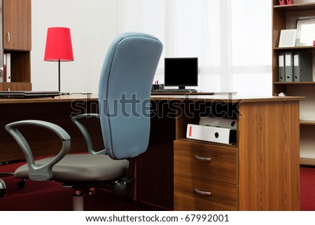 desks and blue chair in a modern office