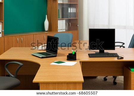 computer and laptop on a desk at modern office