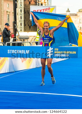 STOCKHOLM - AUG, 24: Lisa Norden crossing the finish line with a swedish flag and she was the winner of the Women ITU World Triathlon Series event Aug 24, in Stockholm, Sweden