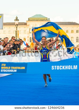 STOCKHOLM - AUG, 24: Lisa Norden running for victory with a swedish flag, winner of the Women ITU World Triathlon Series event Aug 24, in Stockholm, Sweden