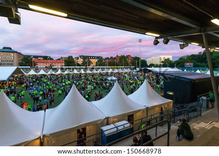 STOCKHOLM - AUG, 17: People gathering before the Midnight Run (Midnattsloppet) event at Zinkensdamm Sports Arena to check in. Aug 17, 2013 in Stockholm, Sweden