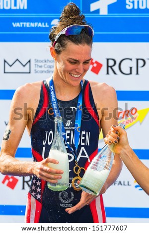 STOCKHOLM - AUG, 24: The winner Gwen Jorgensen celebrates with champagne at the Womens ITU World Triathlon Series event Aug 24, 2013 in Stockholm, Sweden