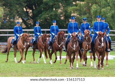 STOCKHOLM - SEPT, 22: A group of riders from the mounted guard entering the arena in The Mounted Guard event for the public in Ryttarstadion Sept 22, 2013 in Stockholm, Sweden