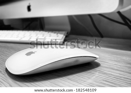 STOCKHOLM - MARCH 18: Mac (magic) mouse, monitor and keyboard on table in room in black and white. March 18, 2014 in Stockholm, Sweden.