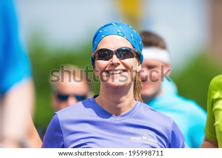 STOCKHOLM - MAY 31: Happy woman in a group of runners in ASICS Stockholm Marathon 2014. May 31, 2014 in Stockholm, Sweden.
