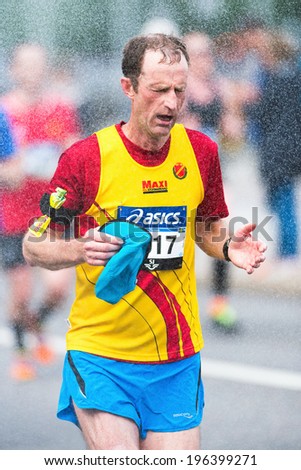 STOCKHOLM - MAY 31: Runner take refreshing water shower in ASICS Stockholm Marathon 2014. May 31, 2014 in Stockholm, Sweden.