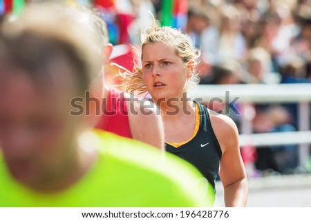 STOCKHOLM - MAY 31: Closeup of a young womans face at the final stretch at Stockholm Stadion in ASICS Stockholm Marathon 2014. May 31, 2014 in Stockholm, Sweden.