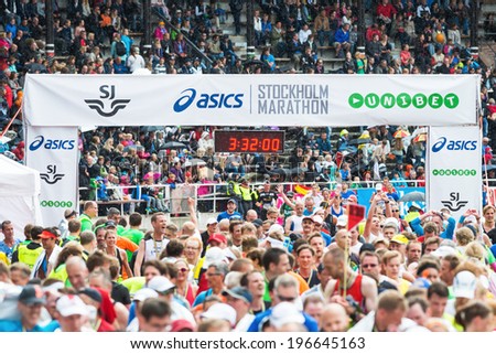 STOCKHOLM - MAY 31: Happy and exhausted runners at the goal in Stockholm Stadion in ASICS Stockholm Marathon 2014. May 31, 2014 in Stockholm, Sweden.
