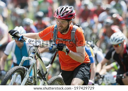 TULLINGE, STOCKHOLM - JUNE 8: Closeup of a man jumped of the bike due to heavy traffic in Lidaloop mountainbike race 2014 during a sunny day in the Swedish nature. June 8, 2014 in Stockholm, Sweden.