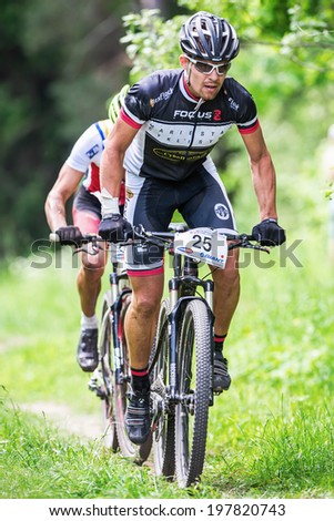 TULLINGE, STOCKHOLM - JUNE 8: Group of elite mountain bikers cycling uphill at Lida loop race 2014 during a sunny day in the Swedish nature. June 8, 2014 in Stockholm, Sweden.