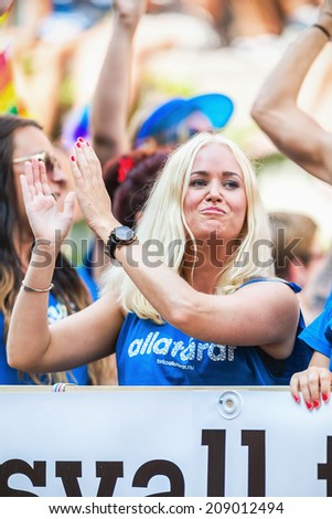 STOCKHOLM - AUG 2: A girl clapping to the crowd during Stockholm Pride Parade at Hornsgatan. August 2, 2014 in Stockholm, Sweden. From RFSL Sundsvall